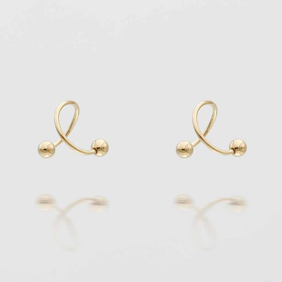 Gold Ayla Earrings on white background.