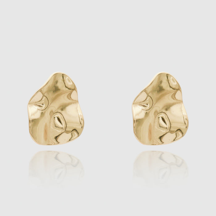 Two abstract gold earrings on white background.