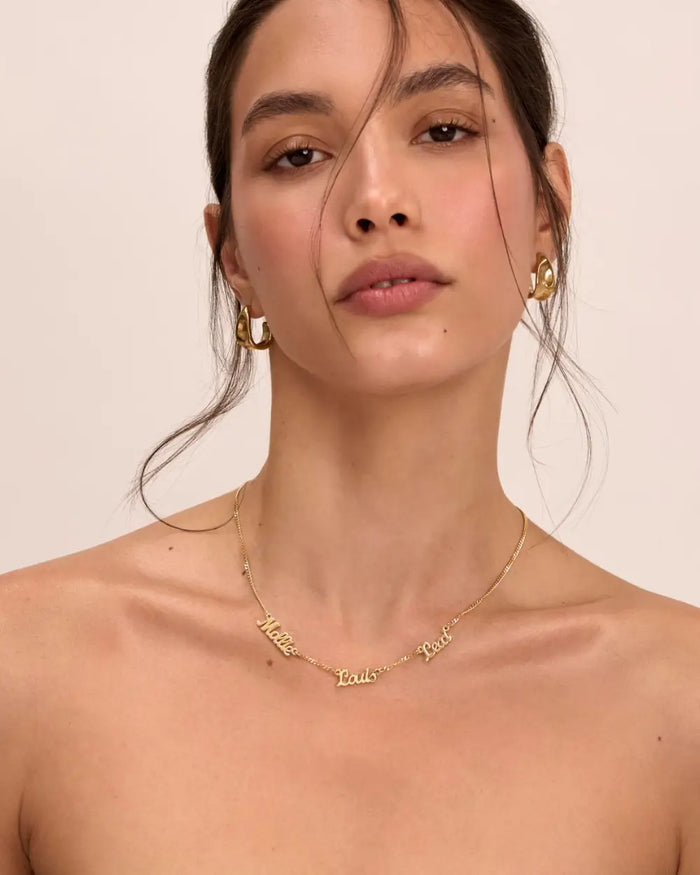 image of model wearing multiple name personalised necklace in gold from prya