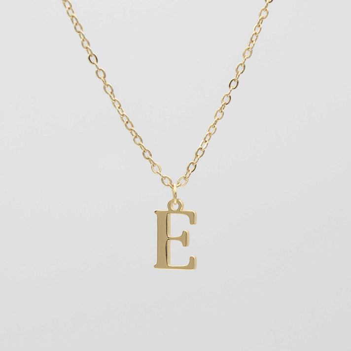 Elegant 18k gold plated initial necklace featuring the letter E on a classic chain. Personalizable and stylish.