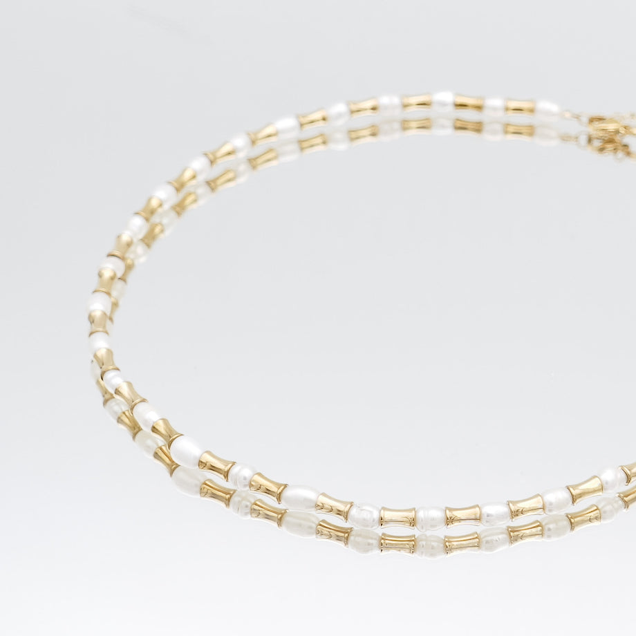 The Eden Pearl Bead Necklace, features delicate gold plated bamboo shaped beads and lustrous pearls from PRYA