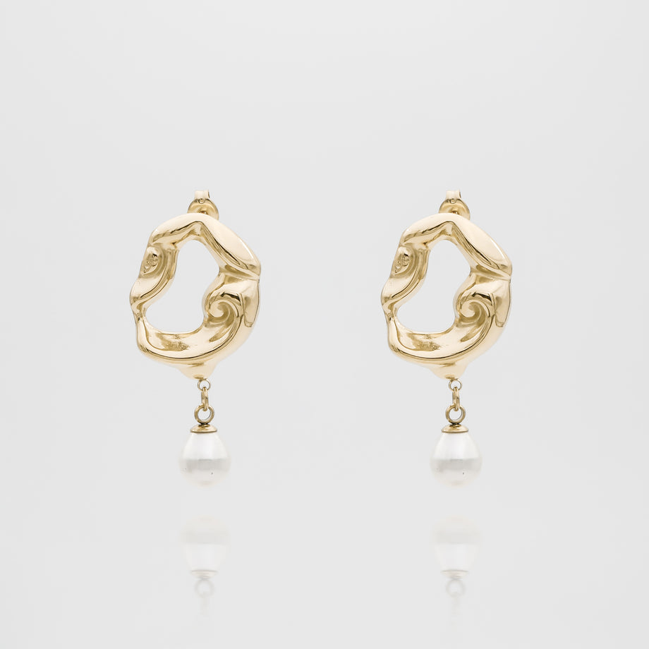 Gold earrings with pearl drops, abstract design.