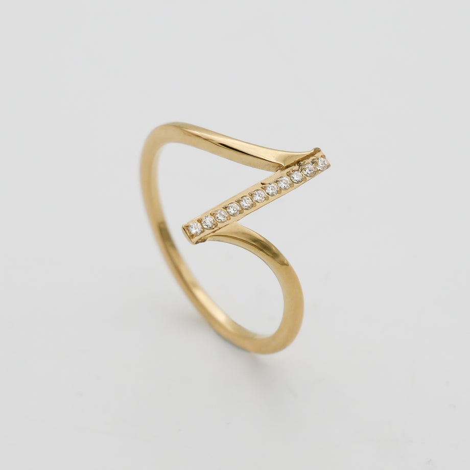 Gold ring with diagonal diamond accents.