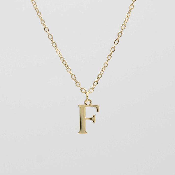 18k gold plated initial necklace featuring a detailed "F" pendant on a classic chain. Personalised jewelry option available.