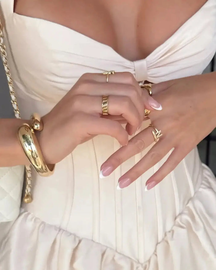 bride wearing gold rings and bracelets from prya