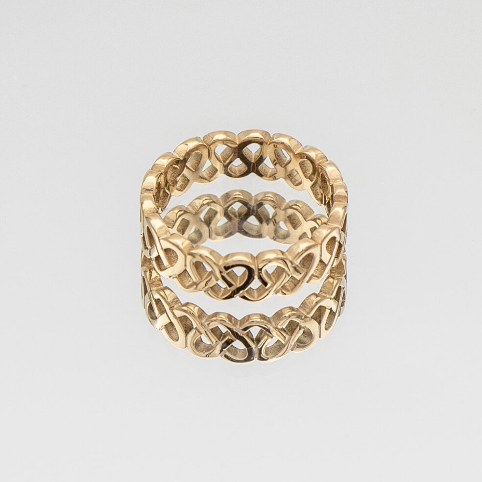 Hallie Ring features a striking gold plated band with a Celtic-inspired design, adorned with a classic love knot from Prya