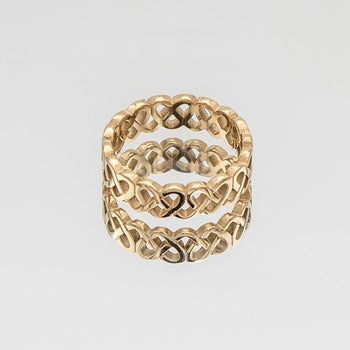 Hallie Ring features a striking gold plated band with a Celtic-inspired design, adorned with a classic love knot from Prya