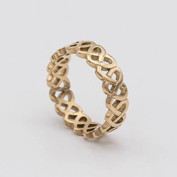 Hallie Ring features a striking gold plated band with a Celtic-inspired design, adorned with a classic love knot from Prya