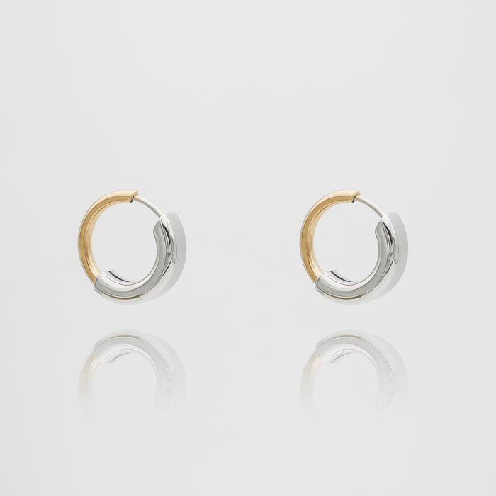 Gold and silver hoop earrings on white background.