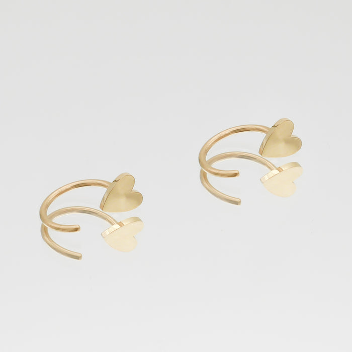 Gold Harper Half Hoop Earrings with heart accents.