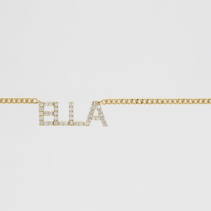 Gold chain with "ELLA" in sparkling letters.