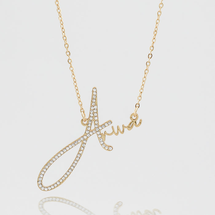 Gold necklace with a diamond-studded "A" pendant.