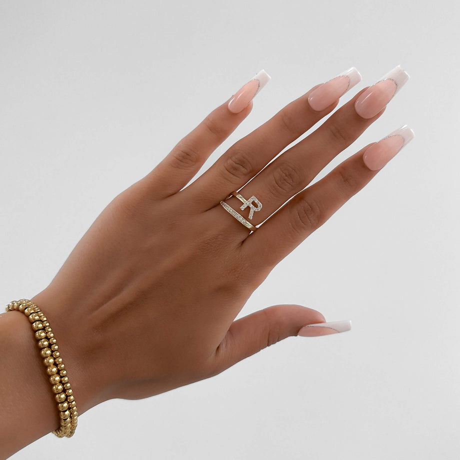 Model wearing Gold Paved, adjustable Icy initial ring in R