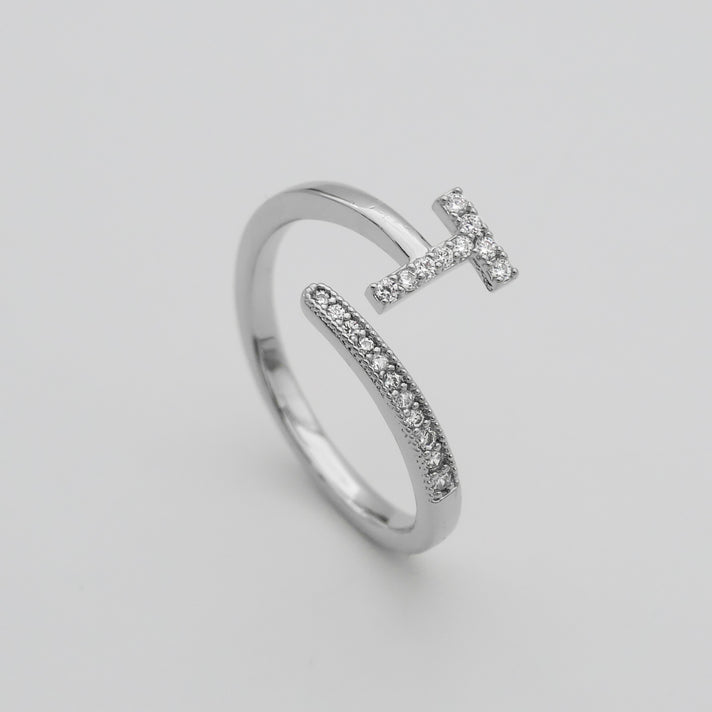 Silver Paved, adjustable Icy initial ring in T