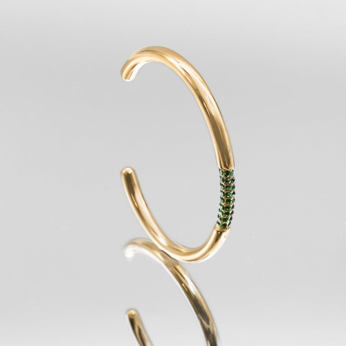 image of gold bangle with emerald cz stones from prya