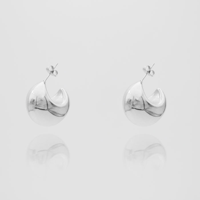 silver half hoop Imani Earrings on white background.