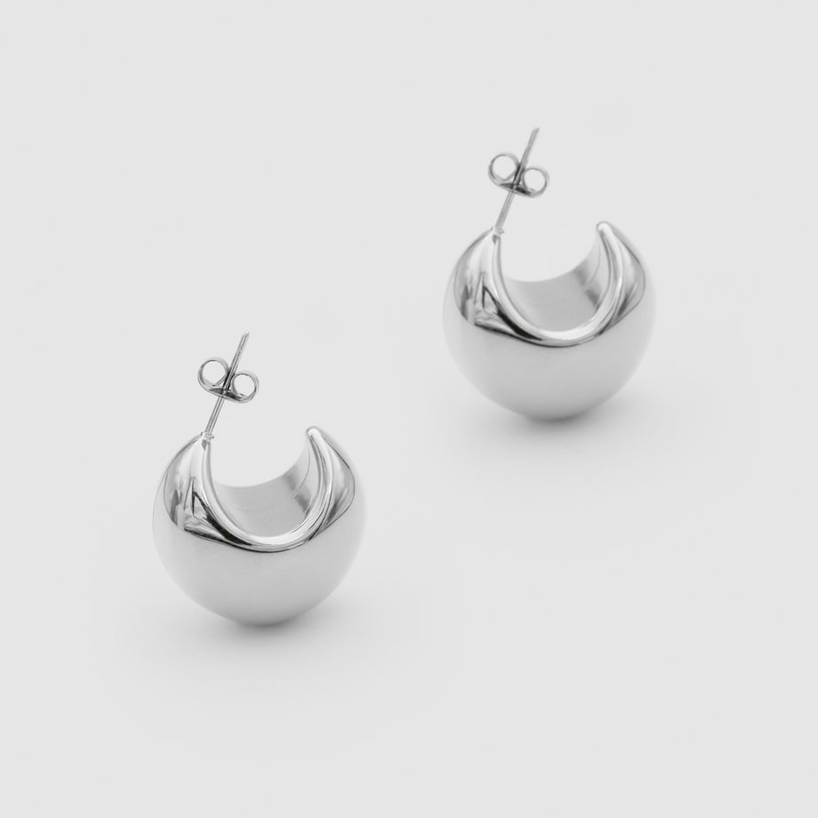 silver half hoop Imani Earrings on white background.