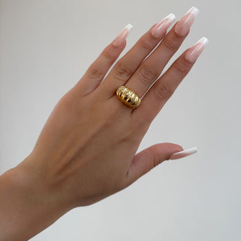 model wearing Inez Chunky Dome Ring, twisted crescent-inspired design crafted in 18k gold plated stainless steel from prya