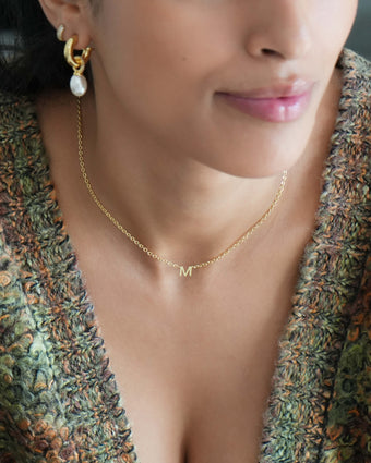 model wearing 18k gold plated jewellery from prya, personalised maia mini initial necklace and pearl earring