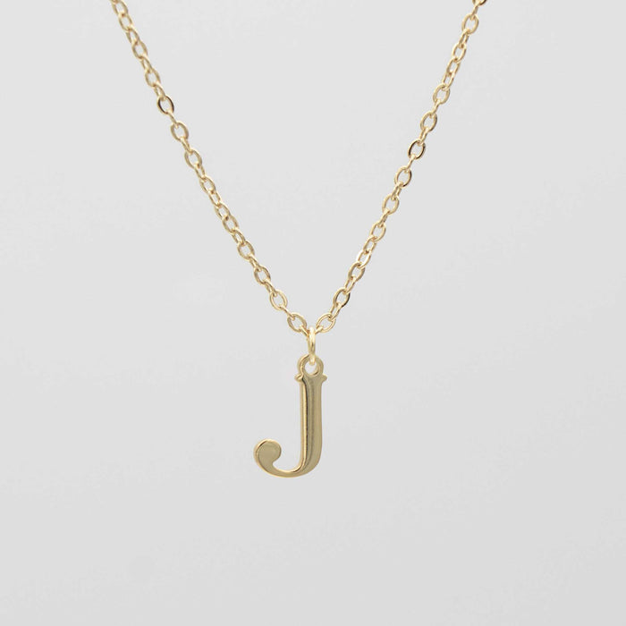 Gold plated initial necklace featuring the letter "J" on a delicate chain, perfect for personalization.