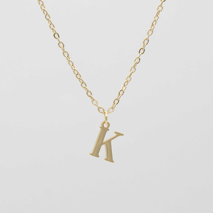 Gold plated initial necklace featuring the letter "K" on a delicate chain, perfect for personalization.