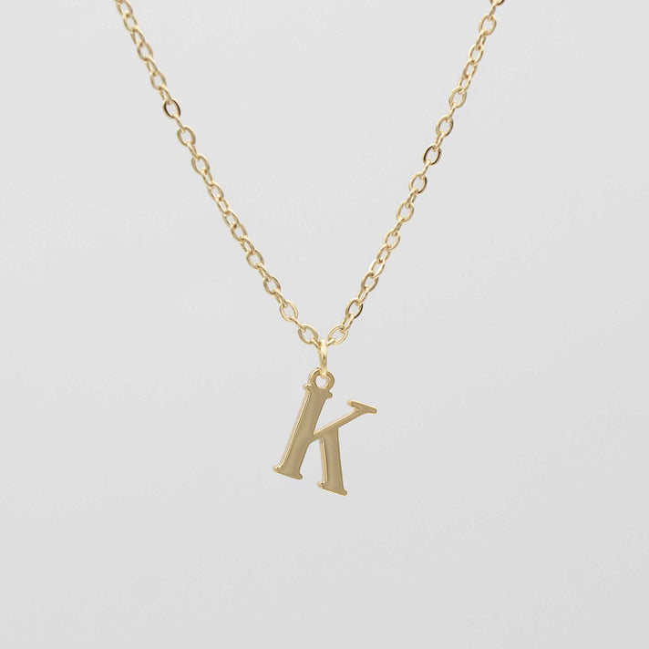 Gold plated initial necklace featuring the letter "K" on a delicate chain, perfect for personalization.