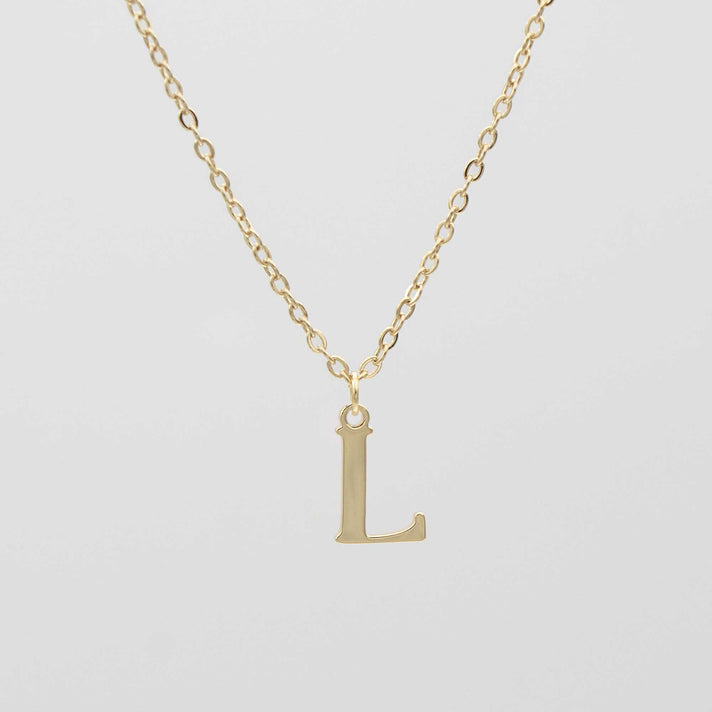 Gold plated initial necklace featuring the letter "L" on a delicate chain, perfect for personalization.