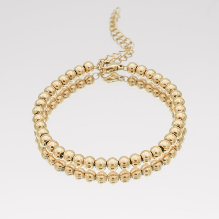 Gold beaded anklet with adjustable chain.