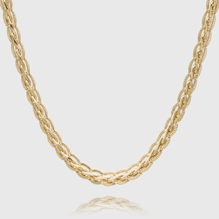 Braided gold necklace on white background.