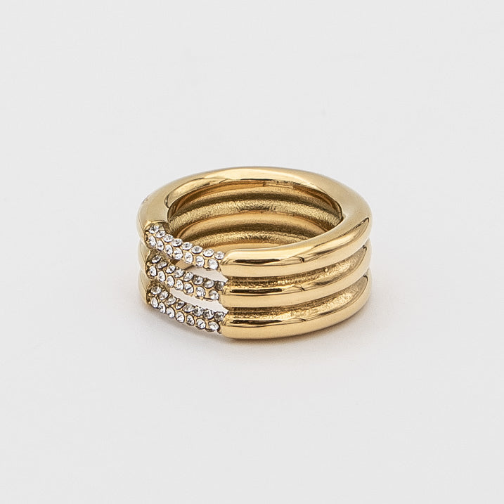 Liana Ring featuring a chunky gold triple band paved with sparkling CZ stones from Prya