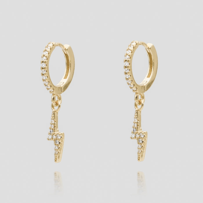 Gold hoop earrings with lightning bolt charms.