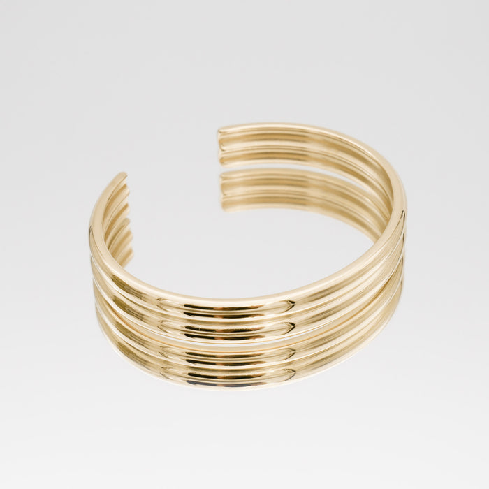 Gold, multi-band open cuff bracelet.