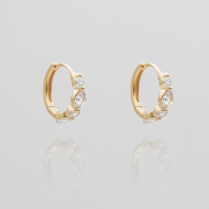 Gold hoop earrings with sparkling gemstones.