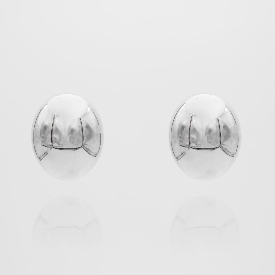 Silver spherical Maeve earrings on white background.