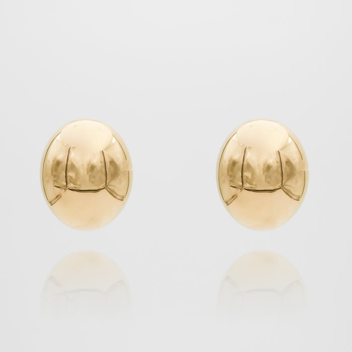 Gold spherical Maeve earrings on white background.