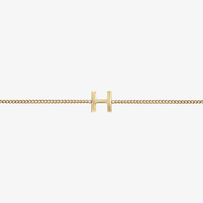  Maia Initial Bracelet with initial pendant on a delicate 18k gold plated chain, perfect accessory for any occasion.