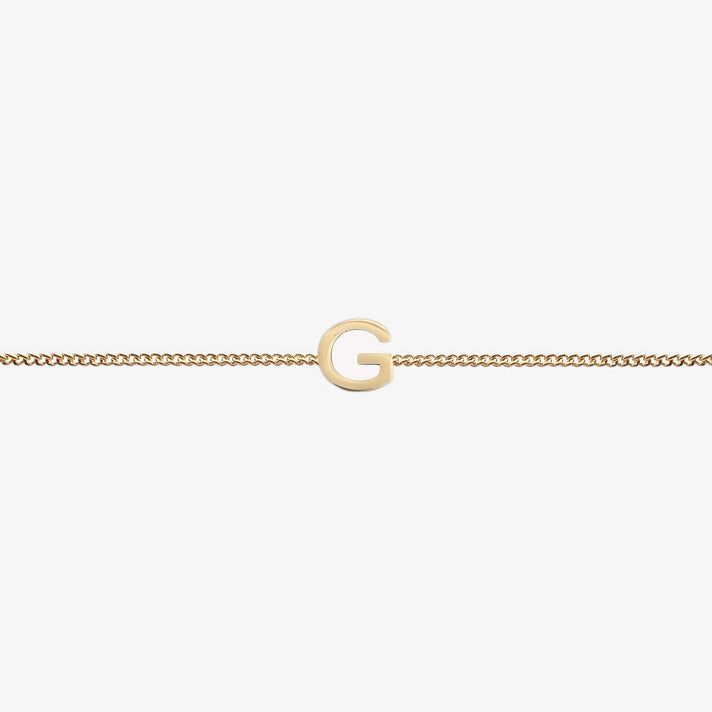  Maia Initial Bracelet with initial pendant on a delicate 18k gold plated chain, perfect accessory for any occasion.