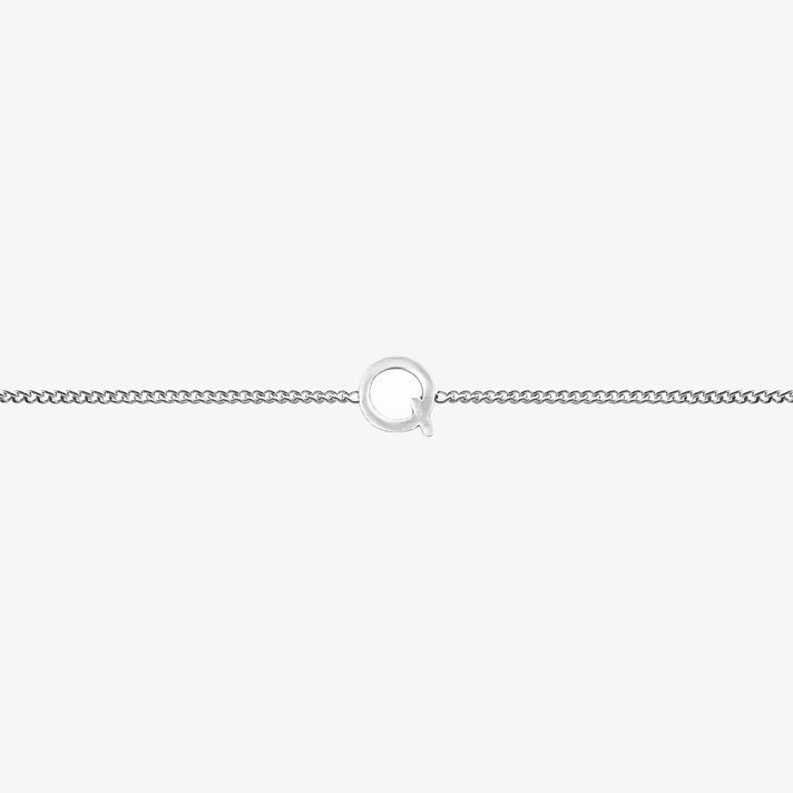 Maia Initial Bracelet with 'Q' pendant on a delicate silver chain, perfect accessory for any occasion.