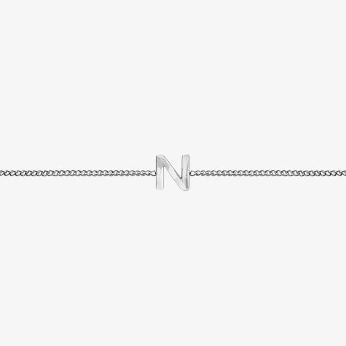 Maia Initial Bracelet with 'N' pendant on a delicate silver chain, perfect accessory for any occasion.