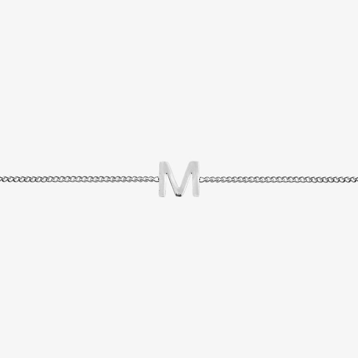 Maia Initial Bracelet with 'm' pendant on a delicate silver chain, perfect accessory for any occasion.
