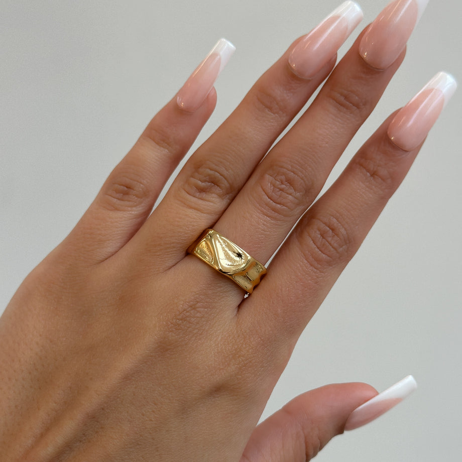 model wearing Malia Ring, featuring a molten design crafted in 18k gold plated stainless steel.