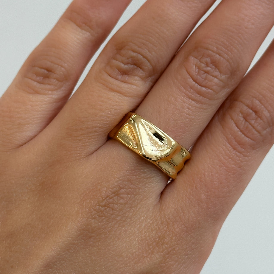 model wearing Malia Ring, featuring a molten design crafted in 18k gold plated stainless steel.