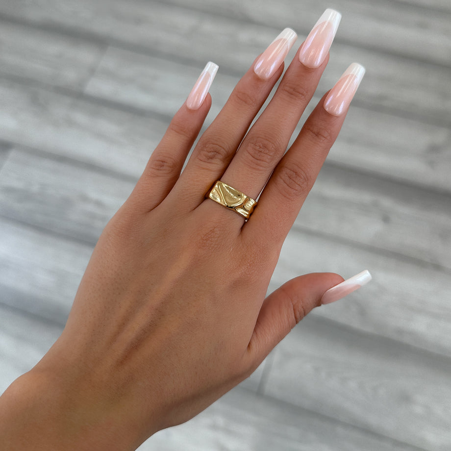 model wearing Malia Ring, featuring a molten design crafted in 18k gold plated stainless steel.