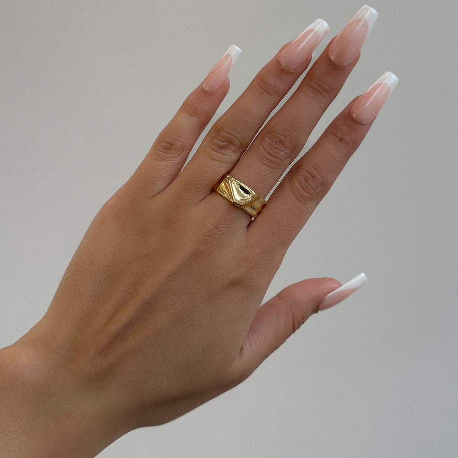 model wearing Malia Ring, featuring a molten design crafted in 18k gold plated stainless steel.