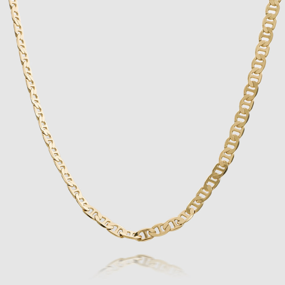 Gold marine chain necklace on white background.