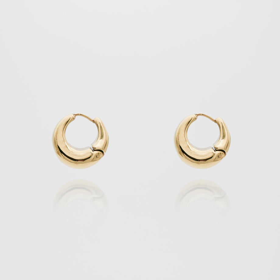 Gold hoop earrings on white background.