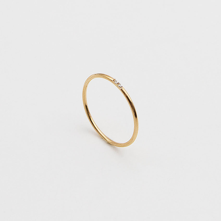 Gold ring with a small diamond.