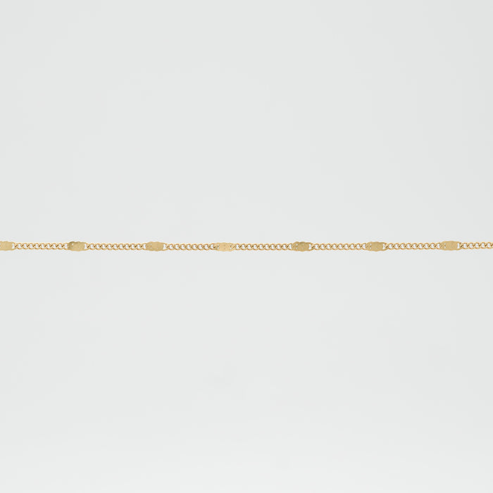 Gold chain with small square details.