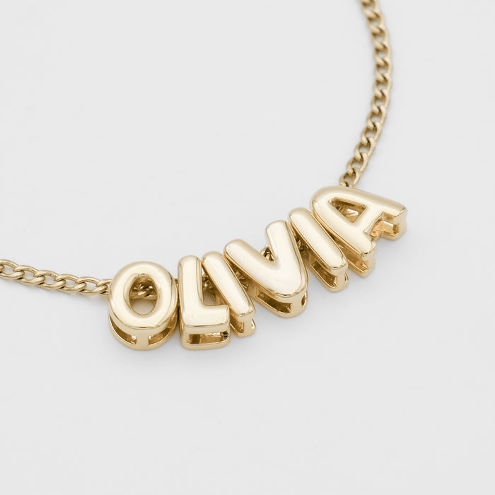 Personalised bubble letter necklace, with gold, silver and rose gold option, featuring customisable ballon-shaped letters, charms, and the & symbol on multiple chain options