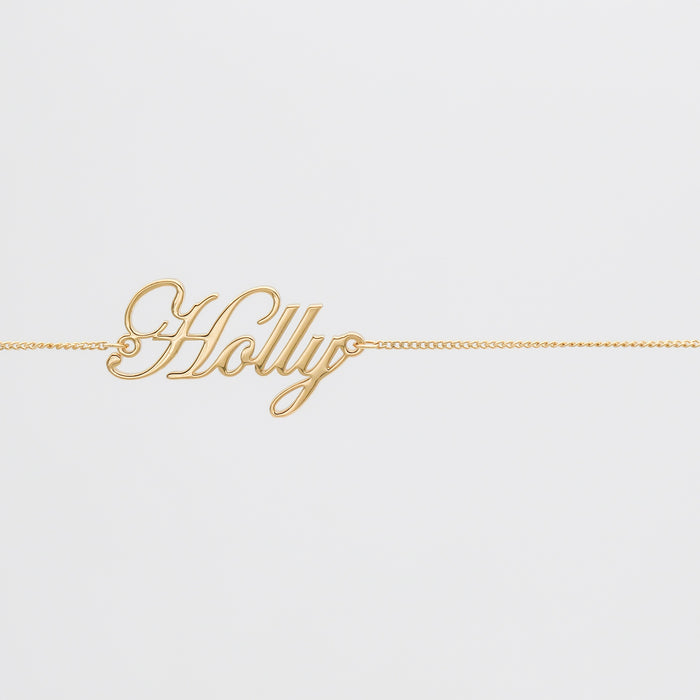 Gold belly chain with "Holly" name pendant.